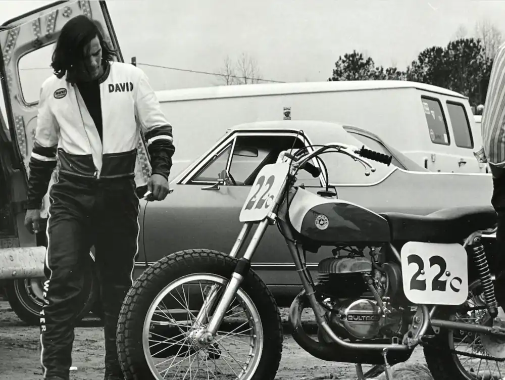 David Aldana in DAVID-branded leathers next to a Bultaco racer